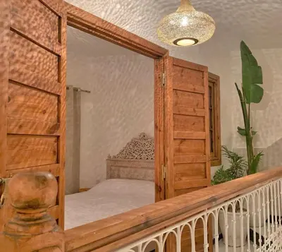 a bedroom with a bunk bed and a mirror at Riad with Outdoor Swimming Pools in Marrakech