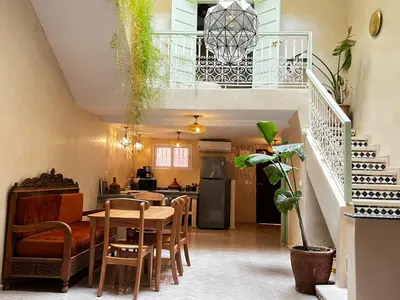 a kitchen and dining room with a table and chairs at Riad with Outdoor Swimming Pools in Marrakech