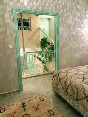 a room with a mirror and a bed and a balcony at Riad with Outdoor Swimming Pools in Marrakech