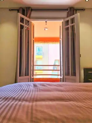 a bedroom with an open door to a balcony at Magnifique Duplex En Plein Hivernage à Marrakech in Marrakech