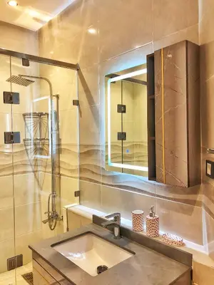 a bathroom with a sink and a shower and a mirror at Magnifique Duplex En Plein Hivernage à Marrakech in Marrakech