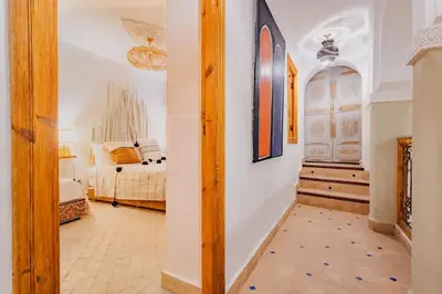 a bedroom with a bed and a room with a mirror at SABOR SAFRA in Marrakech