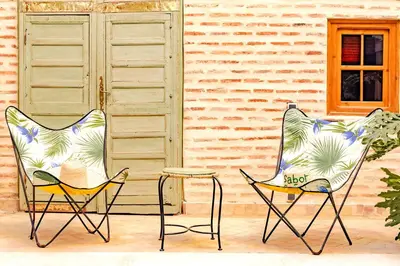 two chairs and a table in front of a building at SABOR SAFRA in Marrakech