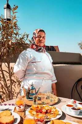 a woman standing in front of a table of food at SABOR SAFRA in Marrakech