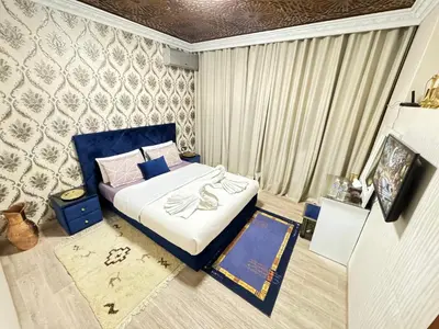 a bedroom with a bed with blue and white sheets at Marrakech aRt in Marrakech