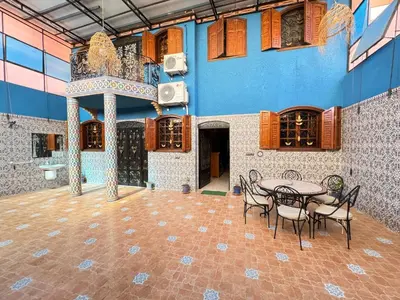 a patio with a table and chairs in a building at Marrakech aRt in Marrakech