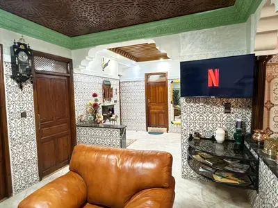 a living room with a brown leather couch in a room at Marrakech aRt in Marrakech