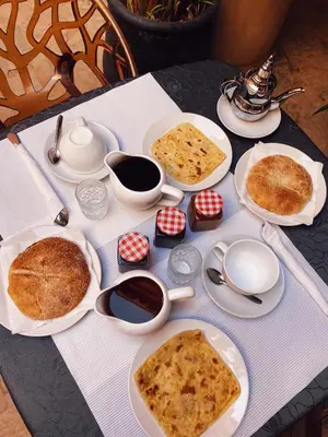 a table with plates of food on top at Riad Sidi Radoine in Marrakech
