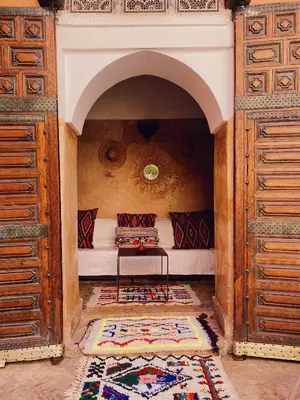 a room with a bed with a table in it at Riad Sidi Radoine in Marrakech