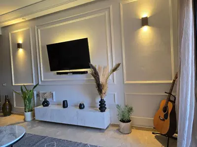 a living room with a flat screen tv on a wall at Bagatelle House 2 in Marrakech