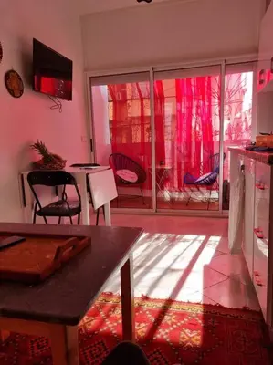 a kitchen with a table and chairs and a window at proche aéroport, idéal pour travailler in Marrakech