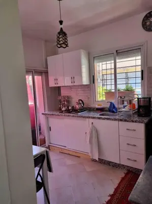 a kitchen with white cabinets and a sink at proche aéroport, idéal pour travailler in Marrakech