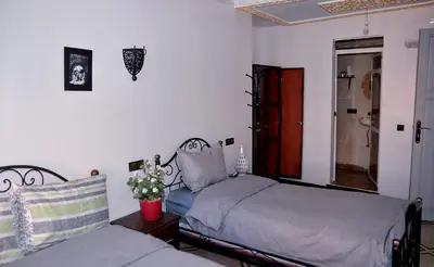 a bedroom with two twin beds and a window at Araf House in Marrakech