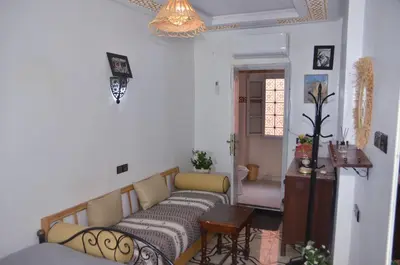 a living room with a couch and a table at Araf House in Marrakech
