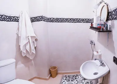 a bathroom with a white toilet and a sink at Araf House in Marrakech