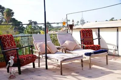 a group of chairs sitting on a patio at Araf House in Marrakech
