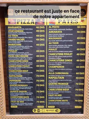 a sign for a pizza restaurant with a menu at Appartement funny house a place jamaa el fna de marrakech in Marrakech