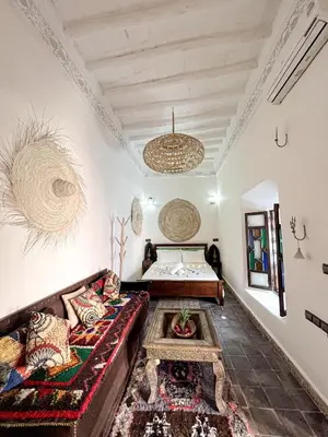 a living room with a couch and a bed at Riad Musa in Marrakech