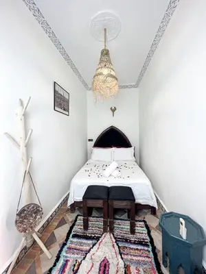 a bedroom with a bed and a rug at Riad Musa in Marrakech