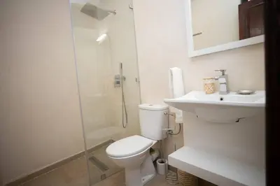a bathroom with a toilet and a sink and a shower at Paisible riad privatif au cœur de Marrakech in Marrakech