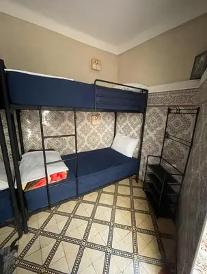 a small room with two bunk beds in it at Happy Marrakchy in Marrakech