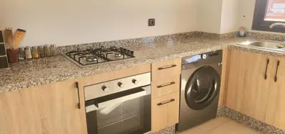 a kitchen with a stove and a washing machine at Appartement tout neuf en plein centre de Marrakech in Marrakech