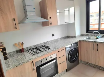 a kitchen with a stove top oven next to a sink at Appartement tout neuf en plein centre de Marrakech in Marrakech