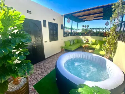 a hot tub on the patio of a house at Riad Dar IMANE in Marrakech