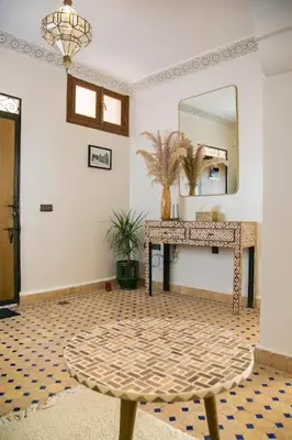 a room with a mirror and a table with a mirror at Riad Sabria in Marrakech
