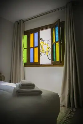 a bedroom with a window with a bike painted on it at Riad Sabria in Marrakech