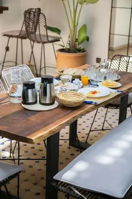 a wooden table with food on top of it at Riad Sabria in Marrakech