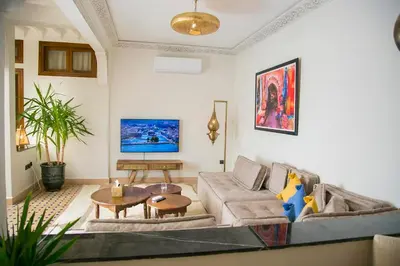 a living room with a couch and a table at Riad Sabria in Marrakech