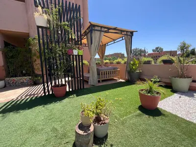a garden with a gazebo and potted plants at Marrakech M Avenue terrasse jardin in Marrakech