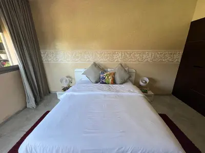 a bedroom with a large white bed in a room at Marrakech M Avenue terrasse jardin in Marrakech