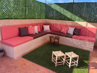 a rendering of a couch with pillows and two tables at Marrakech le joyau villa piscine privée jardin in Marrakech