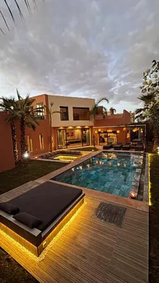 a house with a swimming pool in front of a house at Villa M Piscine chauffée, Hammam sans vis à vis Marrakech in Marrakech