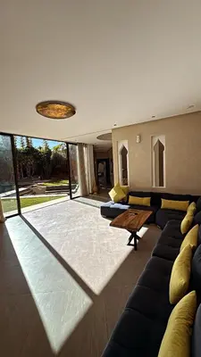 a living room with a couch and a table at Villa M Piscine chauffée, Hammam sans vis à vis Marrakech in Marrakech