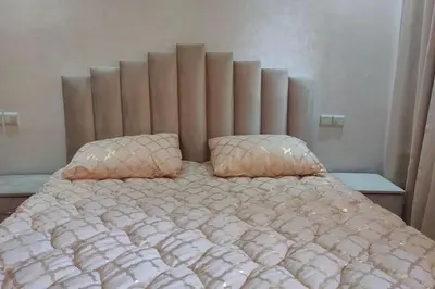 a bed with two pillows on top of it at Duplex haut standing, 3 chambres ,Marrakech,gueliz in Marrakech