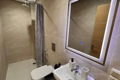 a bathroom with a sink and a mirror and a toilet at Duplex haut standing, 3 chambres ,Marrakech,gueliz in Marrakech