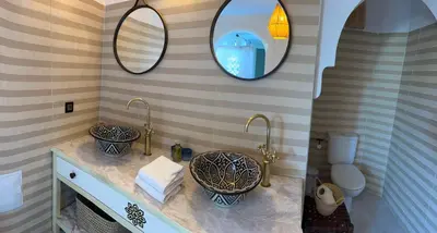 a bathroom with two sinks and a mirror at Magnifique Riad Julilu Privatise au coeur de la Medina 11P in Marrakech