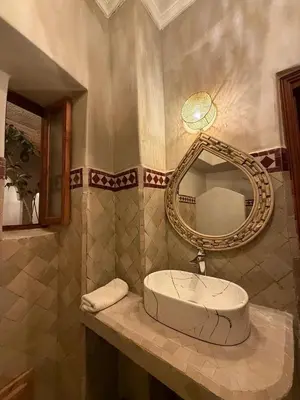 a bathroom with a sink and a mirror at Riad BB Marrakech in Marrakech