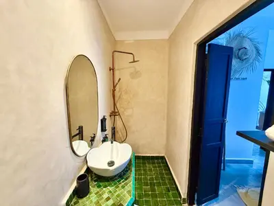 a bathroom with a sink and a mirror at Maison Meurisse JUJ in Marrakech