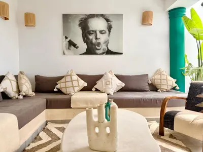 a living room with a couch and a table at Maison Meurisse JUJ in Marrakech