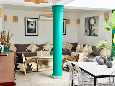a living room with a turquoise pole in the middle at Maison Meurisse JUJ in Marrakech