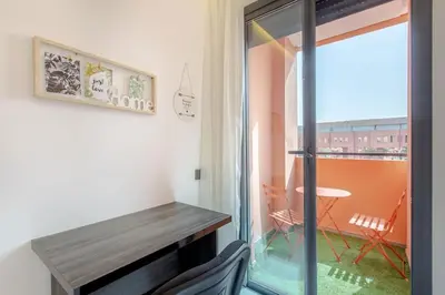 a room with a balcony with a table and a window at New! Marvellous'n modern flat in Marrakech