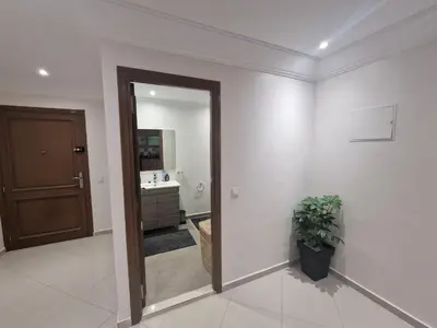 a bathroom with a mirror and a sink in it at appartement de luxe face la marllette in Marrakech