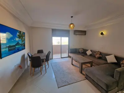 a living room with a couch and a table at appartement de luxe face la marllette in Marrakech