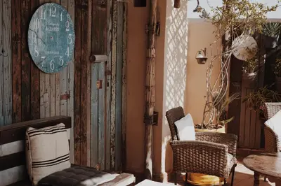 a room with chairs and a clock on the wall at Exclusive and stylish 4-bedroom Riad with plunge pool in Marrakech