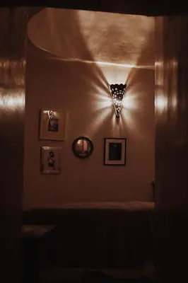 a dark room with a clock on the wall at Exclusive and stylish 4-bedroom Riad with plunge pool in Marrakech