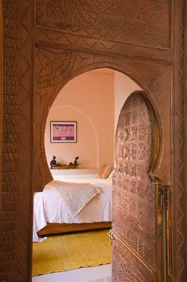 a bedroom with an archway with a bed in it at Exclusive and stylish 4-bedroom Riad with plunge pool in Marrakech